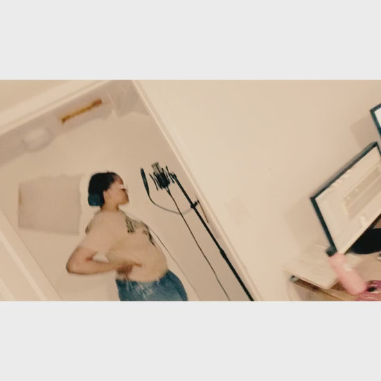 “Artist recording vocals in home studio using microphone and headphones while reading lyrics from notebook — professional vocal recording, songwriting, and sound engineering session by 6iC Studios, creative music production brand.”