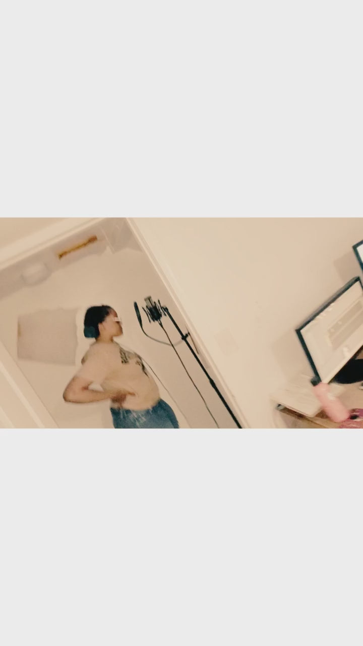 “Artist recording vocals in home studio using microphone and headphones while reading lyrics from notebook — professional vocal recording, songwriting, and sound engineering session by 6iC Studios, creative music production brand.”